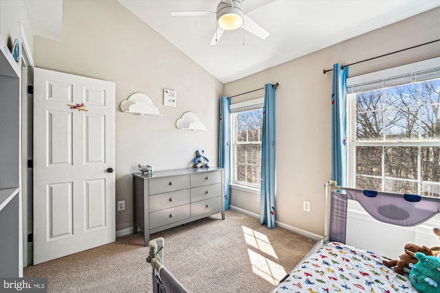 carpeted bedroom featuring ceiling fan, baseboards, and lofted ceiling