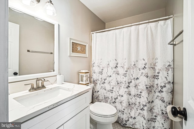 bathroom with vanity, a shower with shower curtain, and toilet