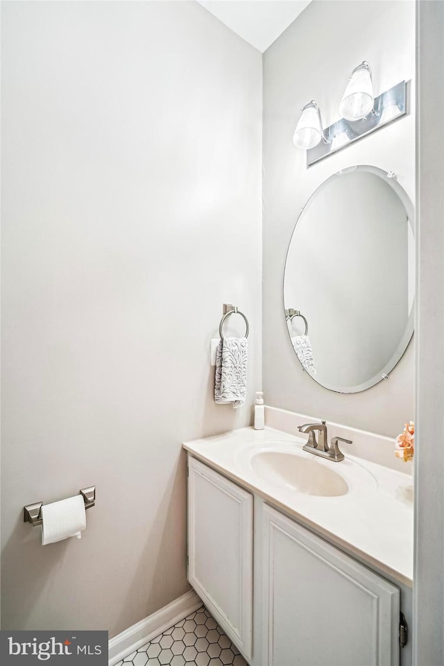 bathroom with tile patterned floors, baseboards, and vanity