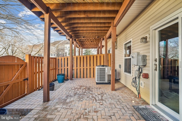 view of patio / terrace with fence, central AC unit, and a gate