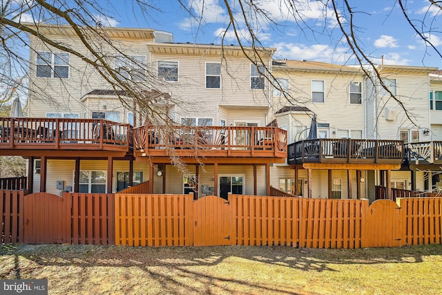 rear view of property with a fenced front yard and a gate