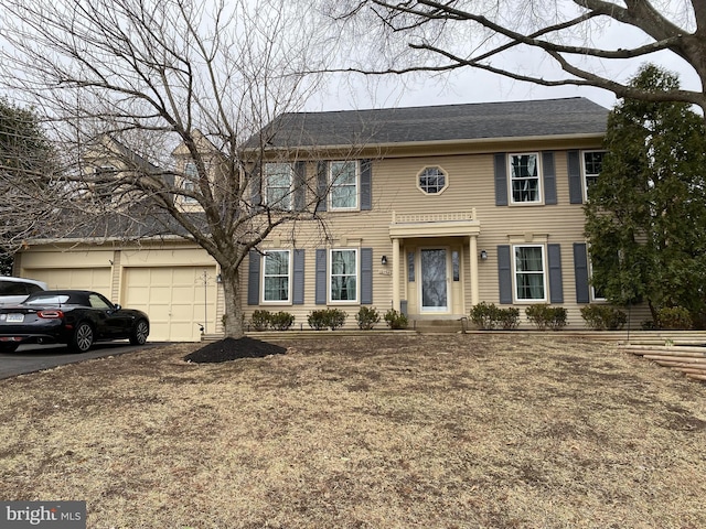 colonial house with a garage and driveway