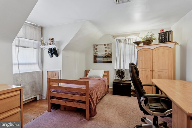 bedroom featuring carpet flooring and vaulted ceiling