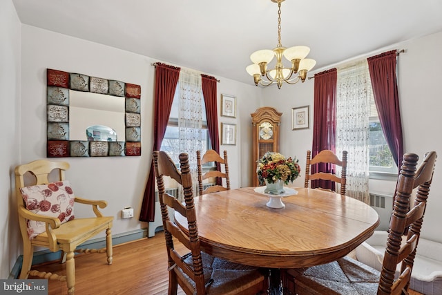 dining space with a chandelier and light wood finished floors
