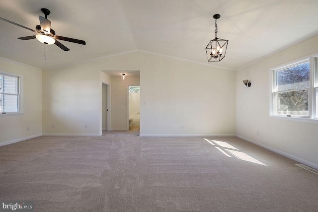 empty room with light carpet, ornamental molding, and plenty of natural light