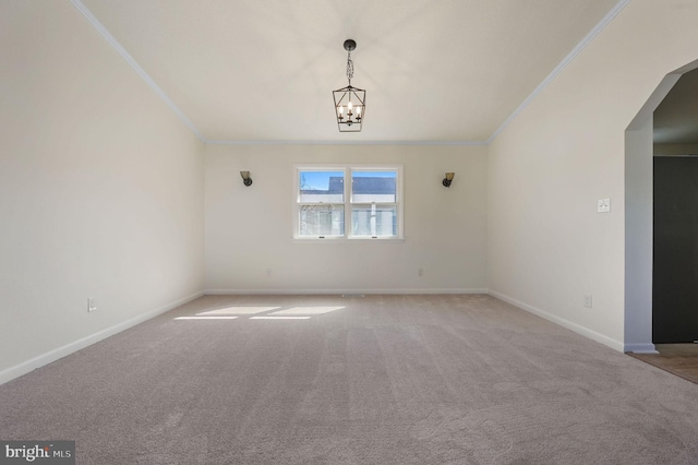 spare room featuring light carpet, ornamental molding, and baseboards