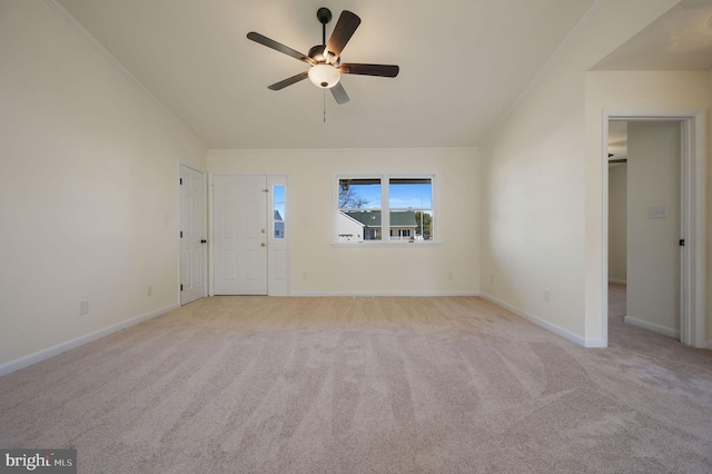 unfurnished living room with lofted ceiling, baseboards, and light colored carpet