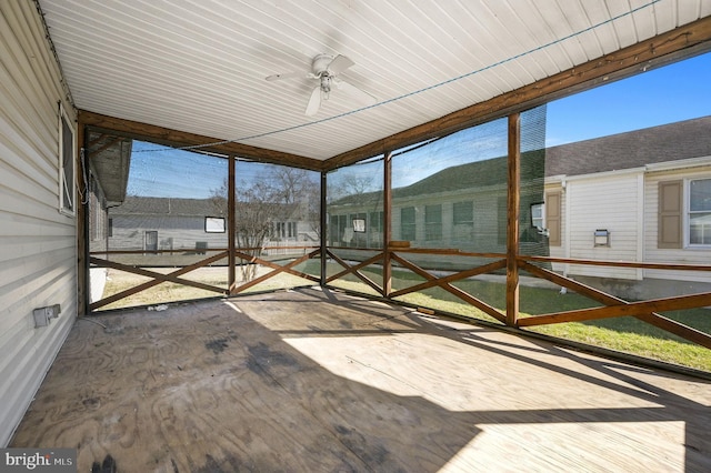 unfurnished sunroom with a ceiling fan