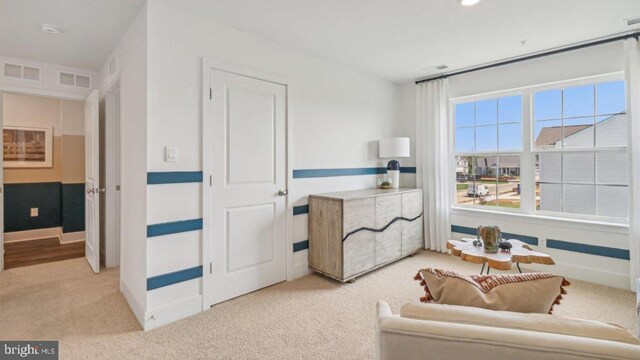 sitting room featuring light carpet and visible vents