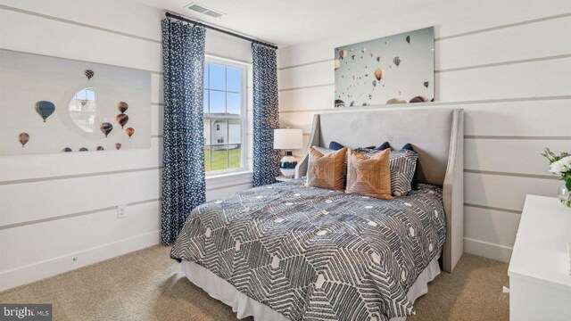 carpeted bedroom featuring visible vents