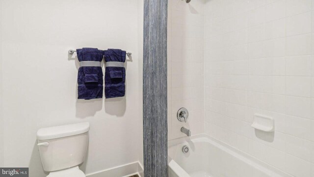 bathroom featuring  shower combination and toilet