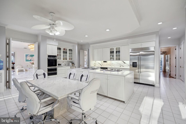 7707 Carlton Pl, Mclean, VA 22102 - kitchen with stainless steel built in refrigerator, white cabinets, crown molding, ceiling fan, and a kitchen island