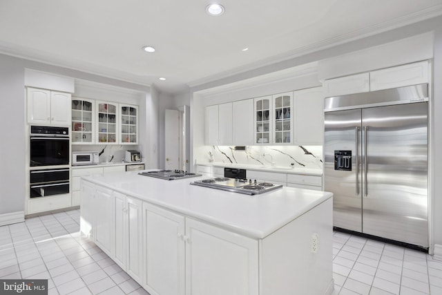 7707 Carlton Pl, Mclean, VA 22102 - kitchen with light tile patterned floors, crown molding, appliances with stainless steel finishes, and a kitchen island