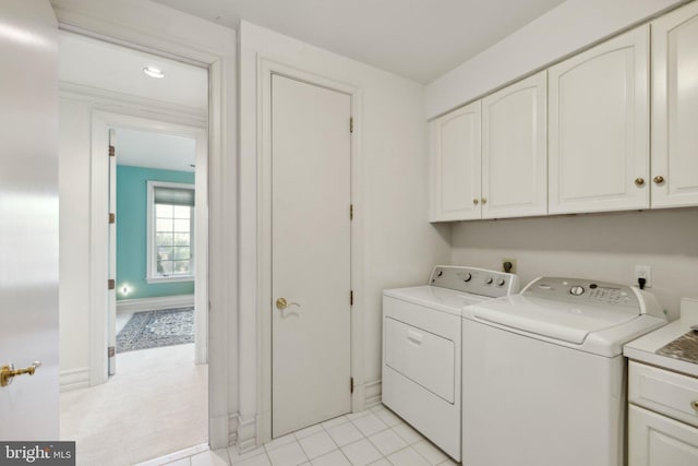 7707 Carlton Pl, Mclean, VA 22102 - washroom featuring washing machine and clothes dryer, cabinet space, baseboards, and light tile patterned floors