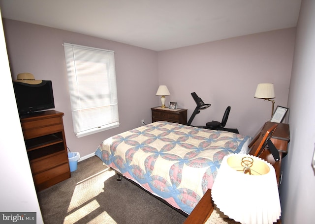 carpeted bedroom featuring baseboards