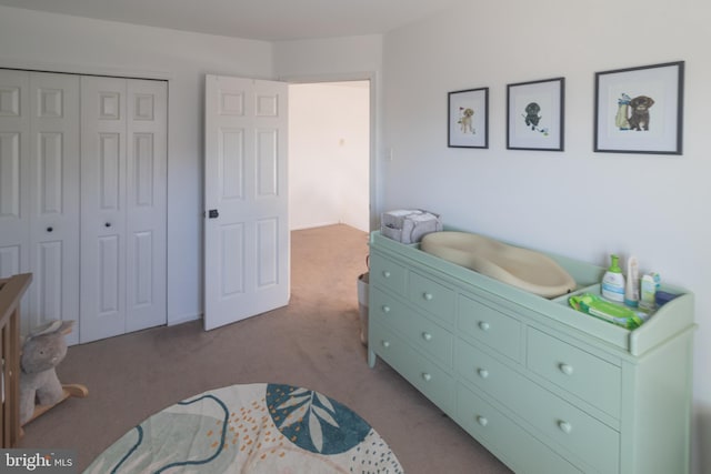 bedroom featuring a closet and light carpet