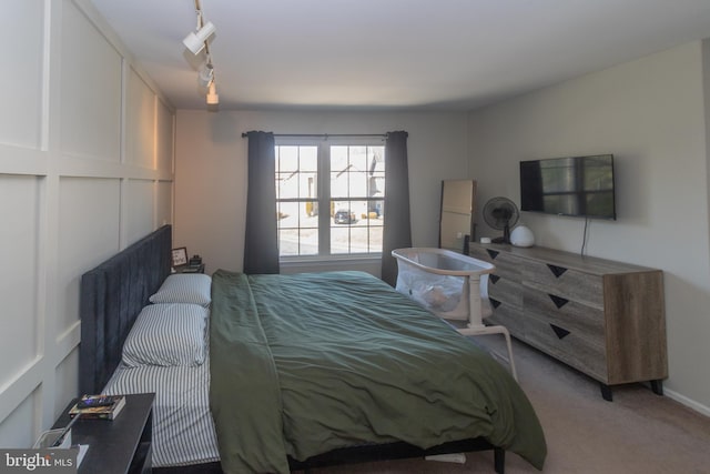 bedroom with carpet and track lighting