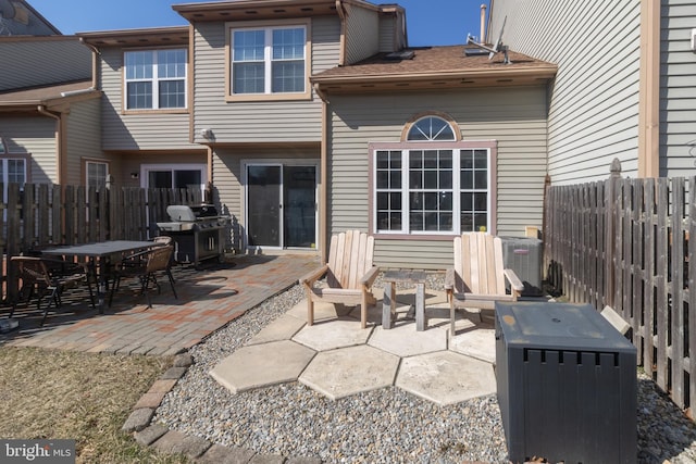 back of house featuring a patio area, a fenced backyard, and central air condition unit