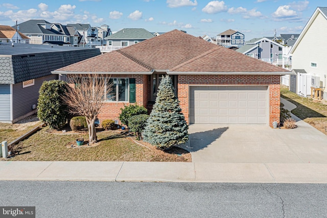 single story home with an attached garage, brick siding, a shingled roof, concrete driveway, and a residential view