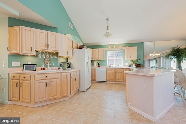 kitchen featuring lofted ceiling, light countertops, visible vents, light brown cabinets, and white appliances