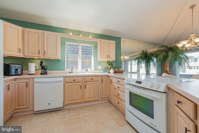 kitchen featuring white appliances, light brown cabinets, and a chandelier