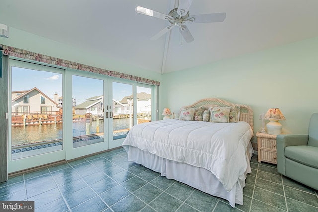 tiled bedroom with vaulted ceiling, access to outside, ceiling fan, and a residential view