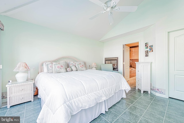 bedroom featuring lofted ceiling, ceiling fan, tile patterned flooring, and ensuite bathroom