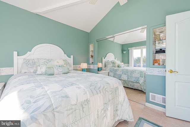 bedroom with tile patterned flooring, visible vents, ceiling fan, and lofted ceiling