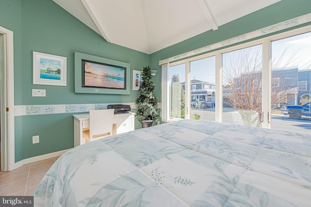 bedroom with light tile patterned floors, baseboards, and vaulted ceiling