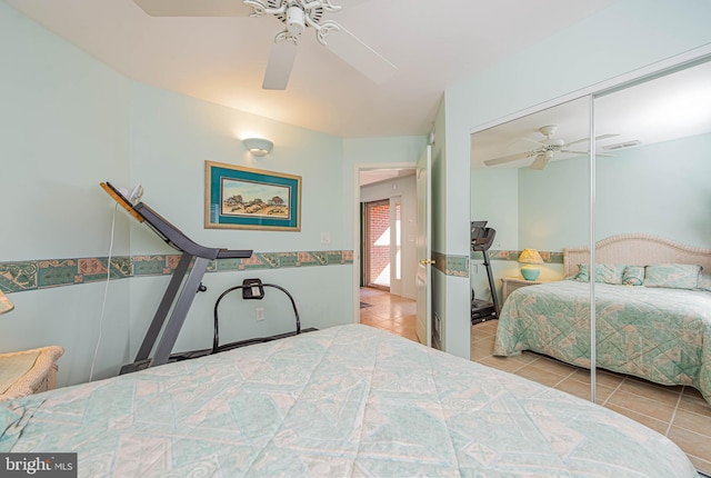 tiled bedroom featuring a closet, visible vents, and a ceiling fan