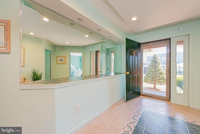 tiled foyer featuring recessed lighting and baseboards