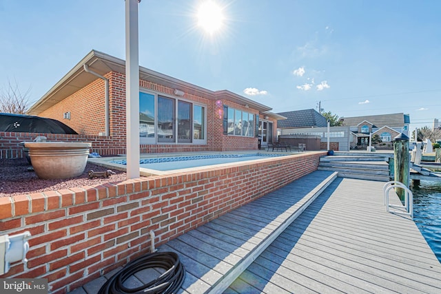 rear view of property with brick siding