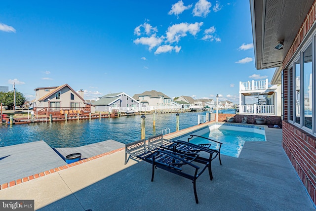 pool with a patio, a dock, a water view, and a residential view