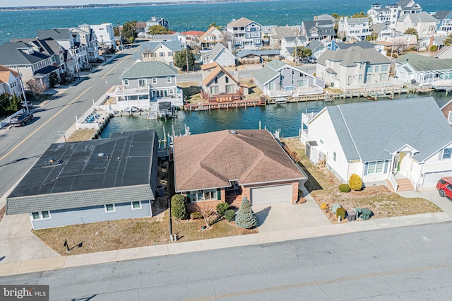 drone / aerial view featuring a water view and a residential view