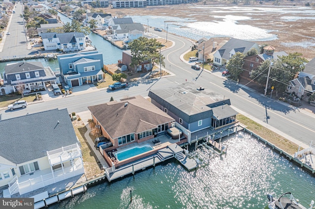 birds eye view of property featuring a water view and a residential view