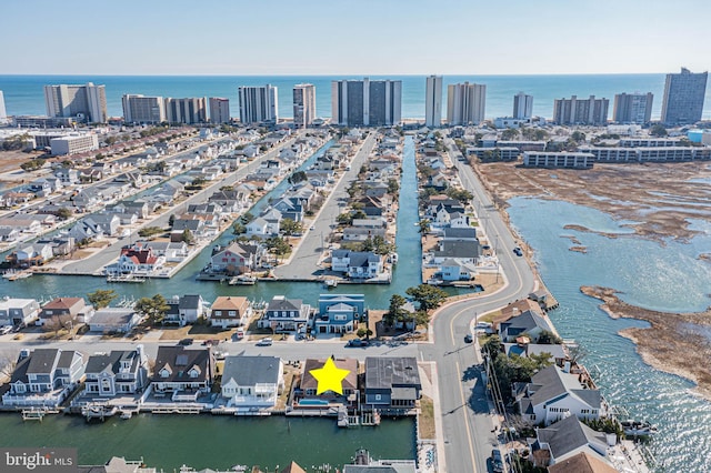 birds eye view of property with a water view and a view of city