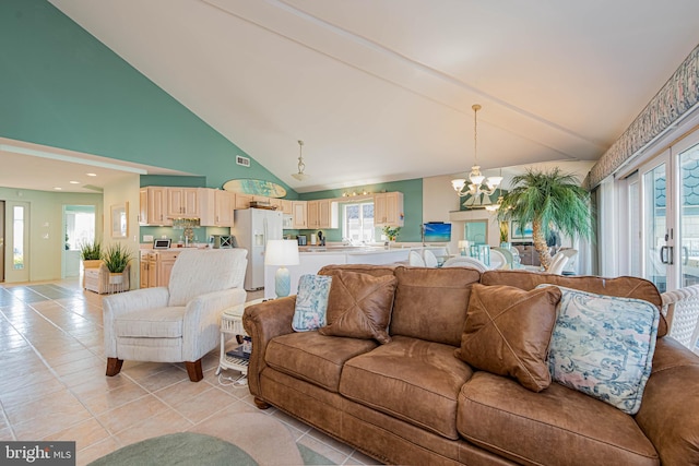 living room featuring light tile patterned floors, high vaulted ceiling, and an inviting chandelier