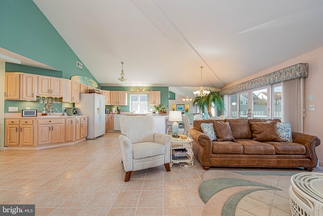 living area featuring a chandelier, lofted ceiling, visible vents, and light tile patterned floors