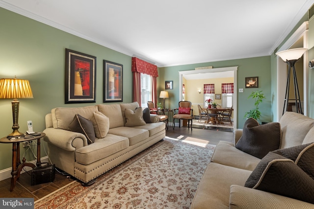 living area featuring crown molding, baseboards, and wood finished floors