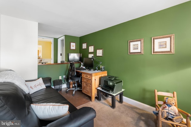 carpeted office featuring baseboards