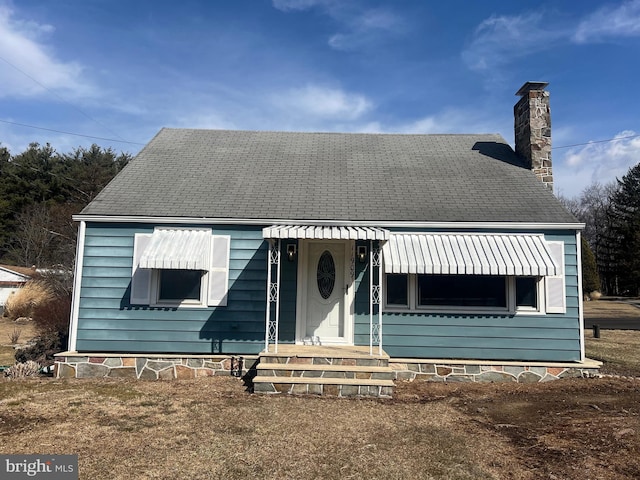 view of front of house featuring a chimney