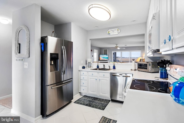 kitchen with a toaster, a sink, ceiling fan, light countertops, and stainless steel appliances