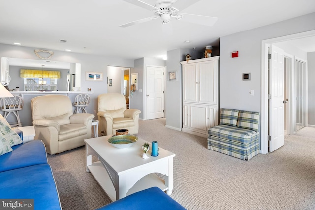 carpeted living room featuring visible vents, baseboards, and ceiling fan