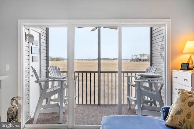 sunroom / solarium featuring a rural view and plenty of natural light