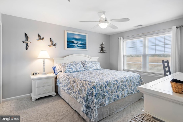 bedroom featuring light carpet, visible vents, baseboards, and a ceiling fan