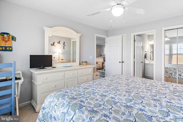 bedroom featuring a ceiling fan, baseboards, and ensuite bathroom