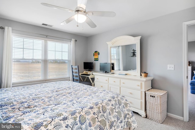 bedroom featuring light carpet, visible vents, a ceiling fan, and baseboards