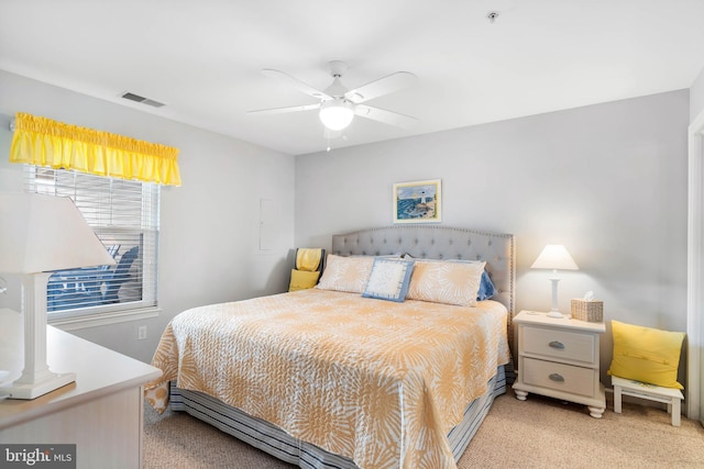 bedroom featuring ceiling fan, visible vents, and light colored carpet