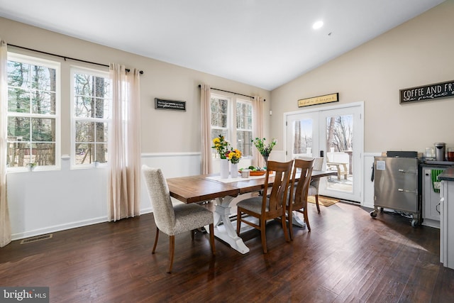 dining area with lofted ceiling, dark wood-style flooring, plenty of natural light, and french doors