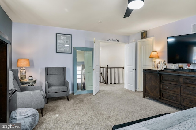 bedroom with ceiling fan, visible vents, and light colored carpet